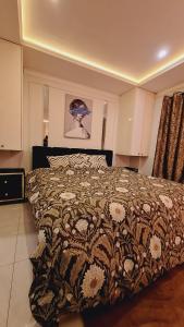 a bedroom with a bed with a comforter on it at Delux Studio Unit I Self Check-in I Bahria Town in Lahore