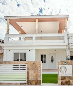 a large white house with at Maximum Beach Hotel in Corozal