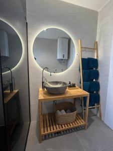 a bathroom with a sink and a mirror at Clear Water Apartment - Seaside in Mandre +25 photos