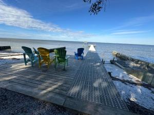 a wooden dock with chairs and a table on the beach at Studio-Bay access-Pet friendly in Gulf Shores