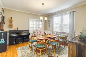 a dining room with a table and chairs and a piano at 1 Mi to Ole Miss Family-Friendly Home! in Oxford