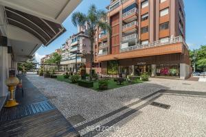 an empty street in a city with tall buildings at Apto c/ Churrasqueira 450m da Praia PNM0202 in Florianópolis