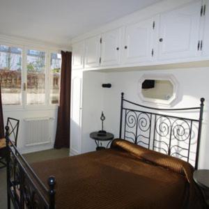 a bedroom with a bed in a room at Hotel De Rouen in Louviers