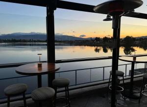a patio with a table and chairs and a view of the water at Sparks 1BR Water Views · Spring & Rooftop Patio in Sparks