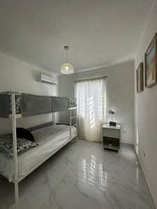 a bedroom with a bunk bed and a table at Santo Domingo Este Stylish Condo in San Isidro