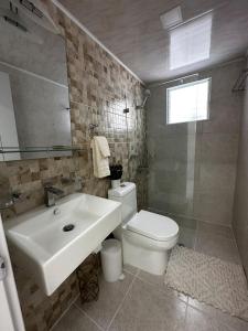 a bathroom with a sink and a toilet at Santo Domingo Este Stylish Condo in San Isidro +10 photos