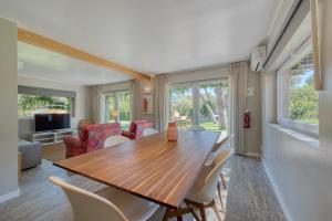 a dining room with a wooden table and chairs at Quinta da Bicuda in Cascais