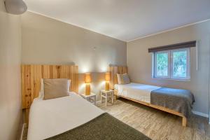 a bedroom with two beds and a window at Quinta da Bicuda in Cascais +37 photos