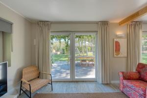 a living room with a couch and a chair and a sliding glass door at Quinta da Bicuda in Cascais