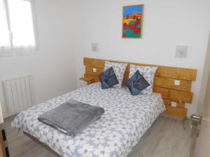 a bedroom with a bed with a blanket on it at La CHANTERELLE in Mortagne