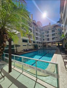 a swimming pool in front of a building at Bombinhas Summer Beach - Praia de Bombas apartamento in Bombinhas