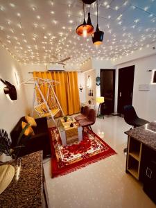 a living room with a couch and a table at Marigold-Luxury Studio in Noida