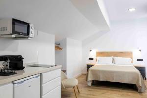 Ένα ή περισσότερα κρεβάτια σε δωμάτιο στο MiRa San Basilio