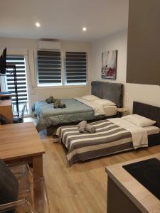 a room with two beds in a room at AniBo Studios & Apartments center 3861 in Thessaloniki