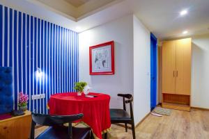 a dining room with a red table and chairs at Hotel Aerostar Grand at Yashobhoomi Convention Center in New Delhi