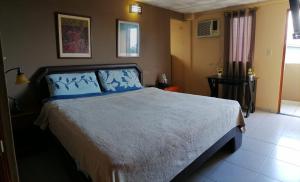 Postel nebo postele na pokoji v ubytování Residencial Tropical