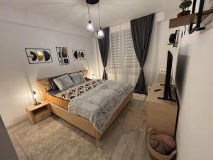 a bedroom with a bed and a television in it at Lovely cozy apartment - Cahul in Cahul