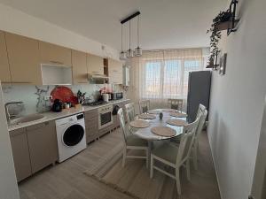 a kitchen with a table and chairs in a kitchen at Lovely cozy apartment - Cahul in Cahul