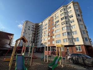 a playground in front of a large apartment building at Lovely cozy apartment - Cahul in Cahul