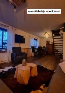 a living room with a table and a couch at 1x Luxe trekkershut of 1x vrijstaand vakantiehuisje Peperkamp in Zelhem +41 photos