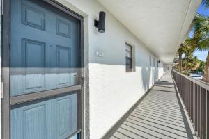 a blue door on the side of a building at Fantastic Views - A Fully Renovated Deluxe Condo W Private Beach Access in Naples