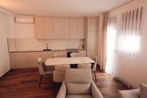 a dining room with a table and chairs at Livinn Apartments-Superior Apartment in Prizren