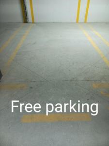 a free parking sign on the floor of a parking garage at MN apartman in Banja Luka