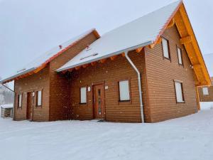 a brick building with snow on the roof at Waldstück in Hasselfelde
