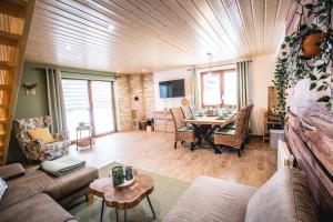 a living room with a couch and a table at Waldstück in Hasselfelde