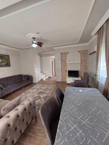 a living room with a table and a couch at villaLemoon in Belek
