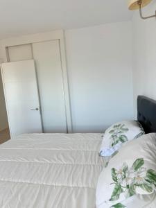 a bedroom with a bed with two pillows on it at Perfect Flat with Ocean Views in Valencia in Miramar +24 photos