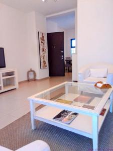 a living room with a glass coffee table at Bip's1 in Dakar