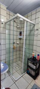 a glass shower in a bathroom with a toilet at Quarto compartilhado Costa Norte in Florianópolis