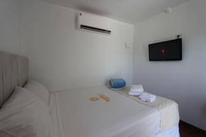 Cama ou camas em um quarto em Wafeh Pampulha Suítes