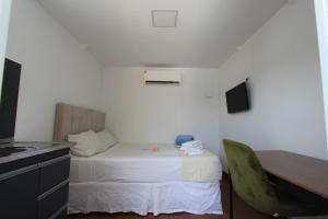 Cama ou camas em um quarto em Wafeh Pampulha Suítes