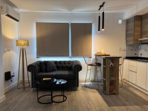 a living room with a couch and a kitchen at Campana Suites in Campana