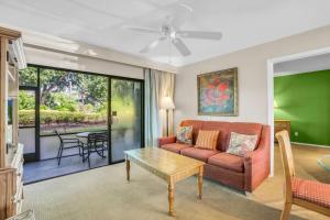 a living room with a couch and a table at Walk From Lanai to Pool and More in Naples