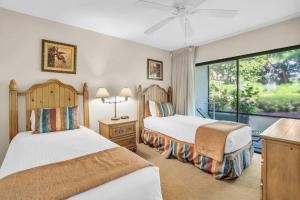 a bedroom with two beds and a large window at Walk From Lanai to Pool and More in Naples