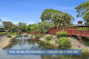 a bridge over a river in a park at Walk From Lanai to Pool and More in Naples