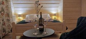 a table with two glasses and a bottle of wine at Tatra West Farm in Dzianisz +48 photos