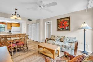 a living room with a couch and a table at First Floor Deluxe Condo in Naples