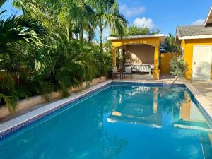 a swimming pool in front of a house at Elegance, Ochi Rios - 2BR Oasis with Exclusive Private Pool!" in Mammee Bay