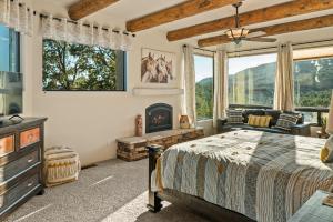 a bedroom with a bed and a fireplace at Hot tub Game room stargazing and mountain views at Happy Javelina in Sedona