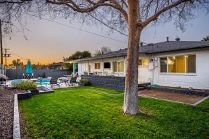 a house with a yard with a tree at Cambridge by Porter Modern Home wHeated Pool Near El Dorado Park in Scottsdale in Scottsdale