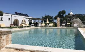 a swimming pool in front of a house at Relais Masseria della Colomba - Agriturismo in Francavilla Fontana