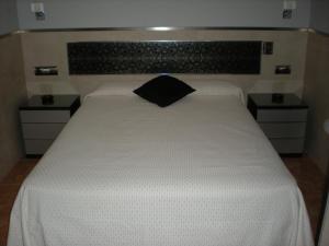 Posteľ alebo postele v izbe v ubytovaní Hostal La Hispanidad