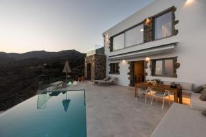 a house with a swimming pool next to a house at Villa Dóma in Sfakia