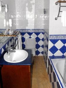 a blue and white bathroom with a sink and a toilet at Hotel Donde Caparrós in Carboneras