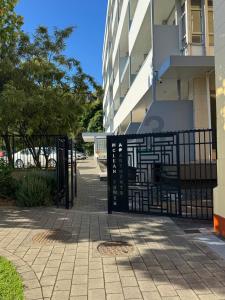 a black metal gate in front of a building at Chic apartment in Art Deco Napier in Napier