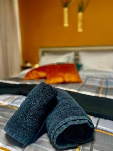 a blue towel laying on top of a bed at D&D rooms Nafplio in Nafplio